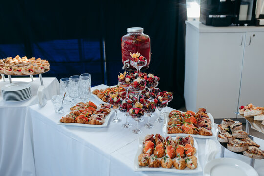 Food and drinks on corporate party table.