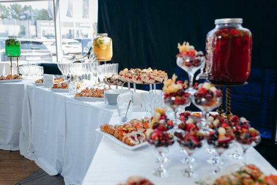 Food and drinks on corporate party table.
