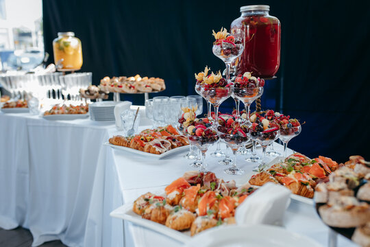 Food and drinks on corporate party table.