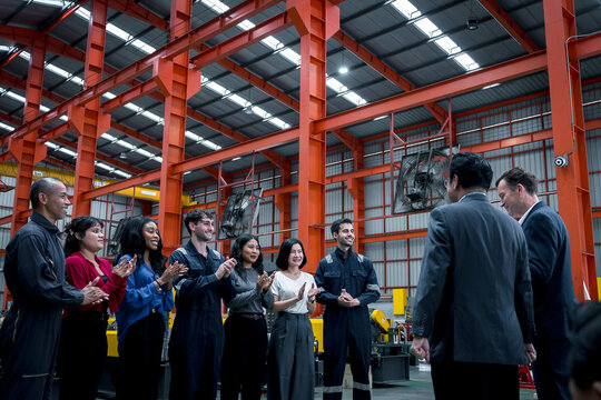 woman worker and engineer under inspection and checking production process on factory station. Factory Engineer. Professional Heavy Industry Engineer Worker. Team of factory workers.