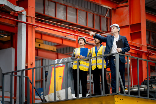 Industrial leadership and factory inspection. Engineers and managers review production operations on a manufacturing platform. Leadership, inspection, industry, teamwork, manufacturing