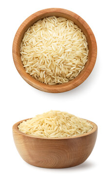 Raw rice in a wooden bow on a white background. Isolated