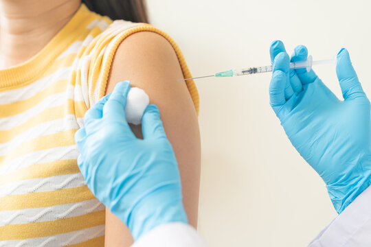 Health care, corona virus, hand of woman nurse, doctor giving syringe vaccine, injection dose on arm sick patient at clinic. Vaccination, immunization disease prevention against flu pandemic influenza