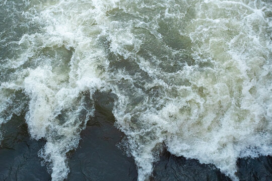 The streams make the bubbles look beautiful, Bubbles on the water, Surface for background, rough. Turbulent water texture with small bubbles.