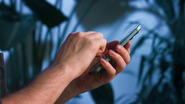 Modern office worker or freelancer using a phone smartphone in a stylish loft studio. Mobile communication, remote work, digital technology, creative business, productivity and modern workspace.
