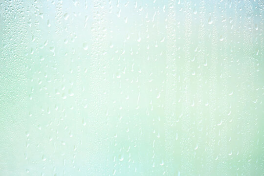Light green gradient raindrops on glass abstract blurred background gentle summer soft green