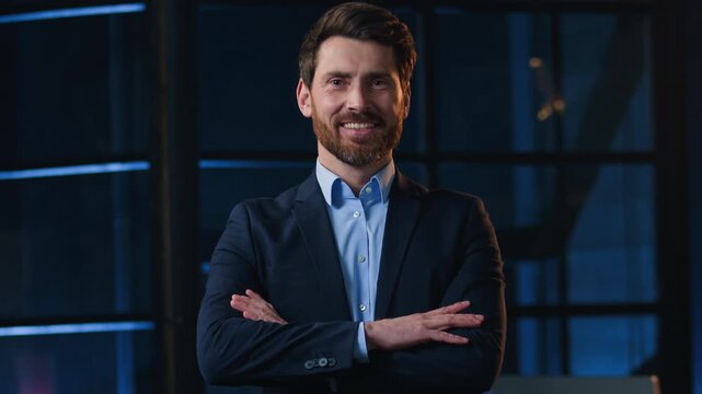 Confident portrait Caucasian mature business man crossing hands smiling looking at camera indoors at night evening office adult middle-aged happy businessman male executive posing smile crossed arms