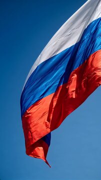 russian flag waving in blue sky. flag of russia