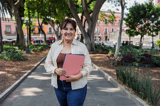 portrait of senior latin woman in public park outdoors in Mexico Latin America, mexican female smiling