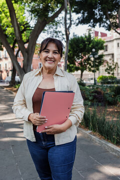 portrait of senior latin woman in public park outdoors in Mexico Latin America, mexican female smiling