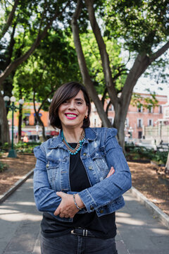 portrait of adult latina woman in public park outdoors in Mexico Latin America, mexican female smiling