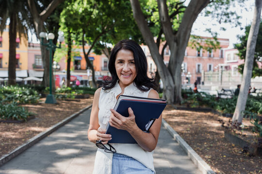 portrait of senior latin woman in public park outdoors in Mexico Latin America, mexican female smiling