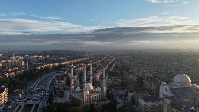 Scenic aerial drone view of an Islamic mosque at sunrise. Urban landscape during the holy month of Ramadan and Eid