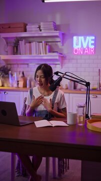 Asian influencer talking in broadcast on social media live on Laptop and smartphone recording online,greeting listeners with coaching life,Stratagem or business at modern home studio.broadcast concept