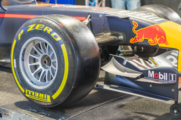 Fototapeta premium Indoor display of a Formula 1 car, featuring Red Bull Racing livery and Pirelli tires Viewed from three-quarter angle, showing left side, front wheel, and underside - Kyiv, Ukraine - June 7, 2025