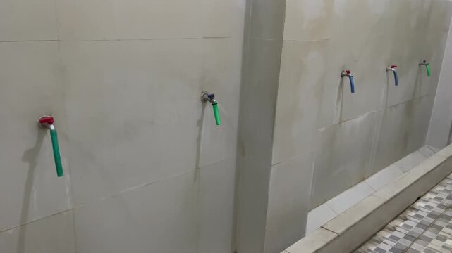 Row of water taps in ablution area at mosque