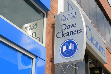 Fototapeta premium exterior building facade and sign of Dove Cleaners, a dry cleaner, located at 1560 Yonge St, Delisle Court, Toronto