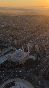 Scenic aerial drone view of an Islamic mosque at sunrise. Urban landscape during the holy month of Ramadan and Eid