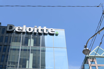 Fototapeta premium Deloitte Canada, an accounting firm, sign outside 8 Adelaide St W, Toronto