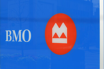 Fototapeta premium close-up of BMO Bank of Montreal sign and corporate logo on window at 1560 Yonge St, Delisle Court, Toronto