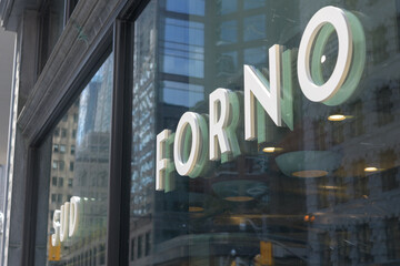 Fototapeta premium sign mounted to display windows at Sud Forno, a restaurant, located at 132 Yonge St, Toronto