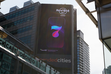 Fototapeta premium electronic billboard featuring ad for Hard Rock Bet on the exterior of The Tenor a shopping mall near Sankofa Square, Toronto
