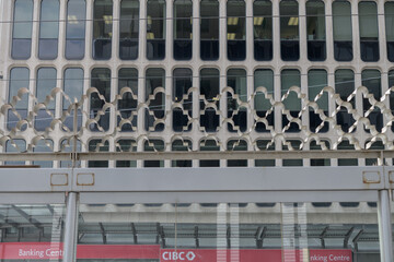 Fototapeta premium decorative iron work at the 512 St Clair trolley transit stop, Yonge St, and a wide view of signage outside CIBC branch located at the Padulo Building St Clair Av W, Toronto