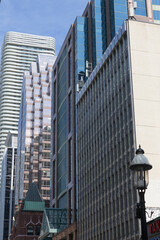 Fototapeta premium (lower right) Softron Tax sign and a view of buildings on the east side of Yonge St from Adelaide St to The Massey Tower condominium complex at 197 Yonge St, Toronto