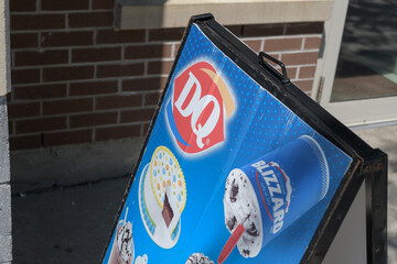 Fototapeta premium a-frame sidewalk sign outside Dairy Queen (DQ) an ice cream shop located at 1646 Bloor St W, Toronto
