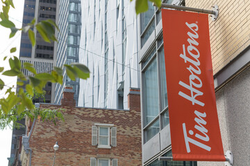 Fototapeta premium wall-mounted projecting banner of Tim Hortons, a coffee shop chain, located here at 18 Yorkville Av and Yonge St, Toronto