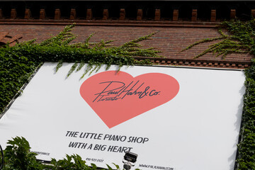 Fototapeta premium sign outside Paul Hahn & Co, a piano store, located at 1058 Yonge St, Toronto (the little piano shop with the big heart)