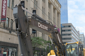 Fototapeta premium Deere heavy construction equipment outside College Park (near the streetcar track replacement/renewal at the intersection of Yonge St and College/Carlton), Toronto