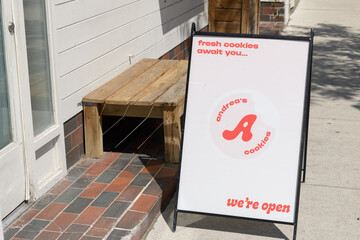 Fototapeta premium a-frame sidewalk sign outside Andrea's Cookies, a cookie shop, located here at 1632 Bloor St W, Toronto
