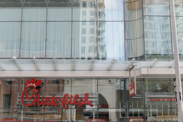 Fototapeta premium exterior building facade and sign of Chick-fil-A, fast food restaurant chain, located here at 709 Yonge St inside One Bloor, Toronto