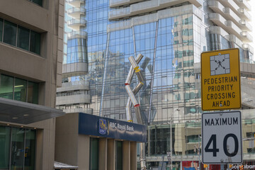 Fototapeta premium wide view of intersection at Yonge and Bloor (RBC Royal Bank at 2 Bloor St E) with view of Ron Arad sculpture, 