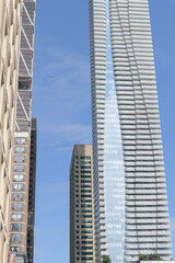 Fototapeta premium (at right) view of One Bloor East designed by Hariri Pontarini Architects, a mixed-use commercial and residential tower at Yonge St, Toronto