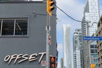Fototapeta premium looking north on Yonge St to sign outside Offset Bar / Café and (in the distance) One Bloor East from Breadalbane St, Toronto