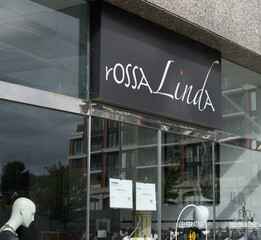 Fototapeta premium exterior building facade and sign over entrance to rossaLinda Boutique, a clothing store, located at 1920 Yonge St, Toronto