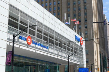 Fototapeta premium wide, perspectival view of BMO Bank of Montreal signage outside south pavilion of First Canadian Place at northwest corner of King and Bay, Toronto