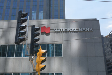 Fototapeta premium exterior building facade and sign of National Bank, a financial institution, located in Roserock Place, 121 King St W, Toronto