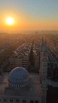 Scenic aerial drone view of an Islamic mosque at sunrise. Urban landscape during the holy month of Ramadan and Eid