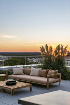 Urban rooftop lounge corner with modern furniture, sunset view, and decorative plants in a contemporary city setting