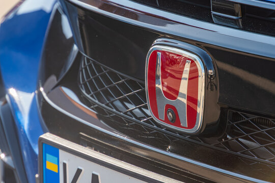 Close-up of Hondas license plate area and grille, featuring a black front section with red Honda emblem Modern, sleek design with aerodynamic features such as grid - Kyiv, Ukraine - September 21, 2025