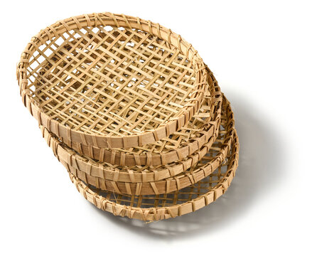 stacked woven bamboo string hopper trays isolated white background, traditional handmade rattan kitchen utensils with grid pattern