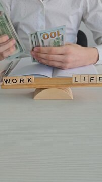 Counting money and organizing life at work desk in the office
