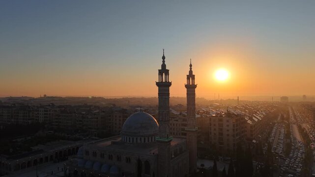 Scenic aerial drone view of an Islamic mosque at sunrise. Urban landscape during the holy month of Ramadan and Eid