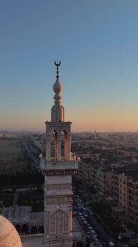 Scenic aerial drone view of an Islamic mosque at sunrise. Urban landscape during the holy month of Ramadan and Eid
