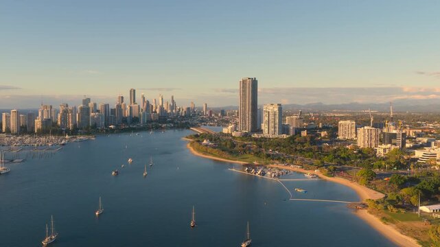 Horizontal aerial footage trucking left while panning right over Southport, Surfers Paradise and the Gold Coast Marathon, Queensland, Australia