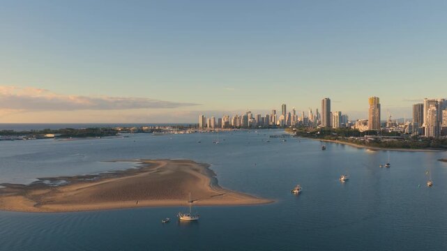 Horizontal aerial footage trucking right over the Southport Broadwater sandbar with the Surfers Paradise skyline in the background, Gold Coast, Queensland, Australia