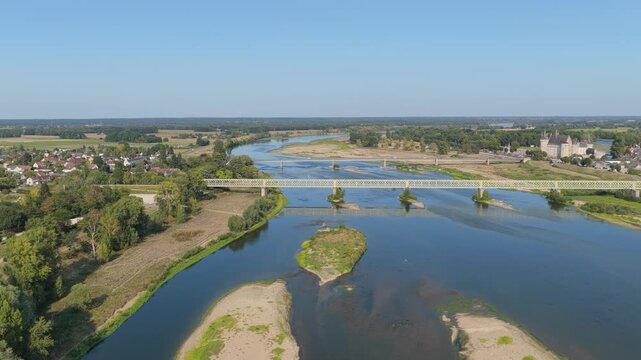 A metal bridge spanning the Loire River in Sully-sur-Loire, France, aerial view.